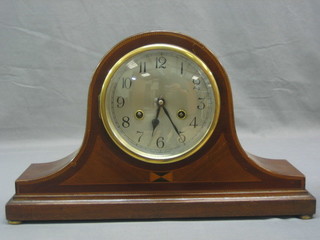 A striking mantel clock with silvered dial and Arabic numerals contained in an inlaid mahogany Admiral's hat shaped case