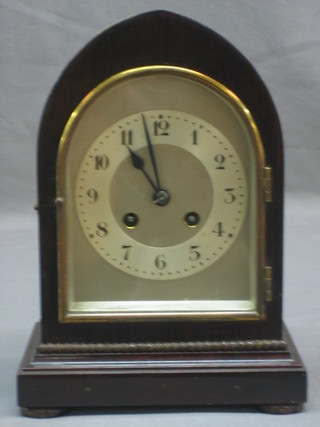 A chiming mantel clock with silvered dial and Arabic numerals contained in a lancet mahogany case