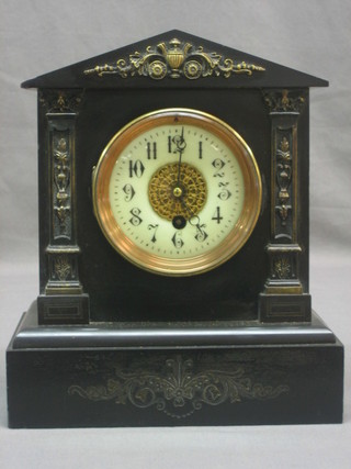 A French Victorian 8 day mantel clock with enamelled dial and Arabic numerals contained in a black marble case with gilt metal embellishment