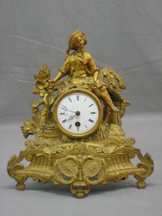 A 19th Century French 8 day mantel clock with enamelled dial and Roman numerals, contained in a gilt spelter case surmounted by a figure of lady gardener