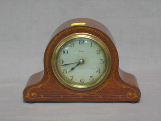 A French 8 day bedroom timepiece with silvered dial and Arabic numerals contained in an arch shaped inlaid mahogany case