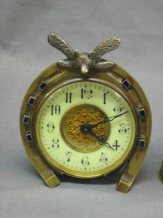A Victorian Continental bedroom timepiece with enamelled dial and Arabic numerals contained gilt metal horse shoe shaped case