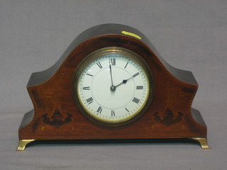 An 8 day bedroom timepiece with enamelled dial and Roman numerals contained in an arch shaped inlaid mahogany case