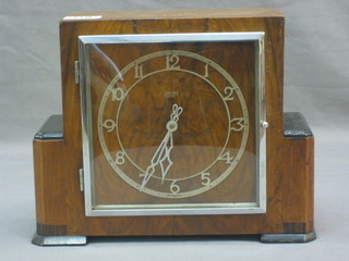 An Art Deco mantel clock with silvered dial contained in a walnut case by Smith Enfield