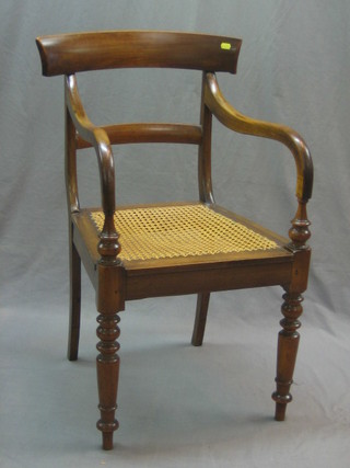 A 19th Century mahogany bar back carver/desk chair with woven cane seat, raised on turned supports