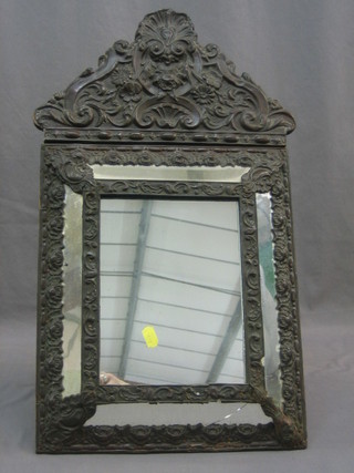 An Eastern plate mirror contained in an embossed metal frame 23" (1 pane f)