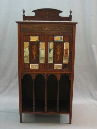 A Victorian rosewood music cabinet with shelved interior enclosed by a panelled glazed door, the base fitted a 4 division Canterbury 24"