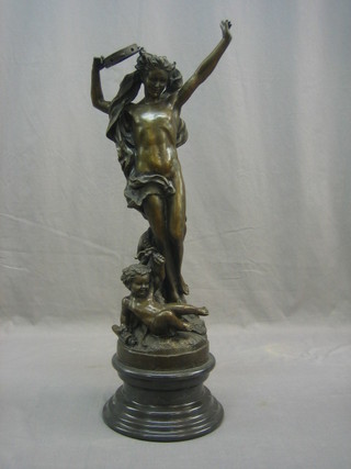 A bronze figure of a standing dancing lady with seated child  19", raised on a marble socle base