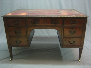 A 19th Century Chippendale style mahogany desk with inset tooled leather writing surface above 1 long and 6 short drawers, raised on square tapering supports ending in brass caps and castors 48"