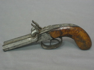 A 19th Century double barrelled Percussion pistol with 4 1/2" octagonal barrels, walnut grip, finger guard marked A & G, barrels corroded