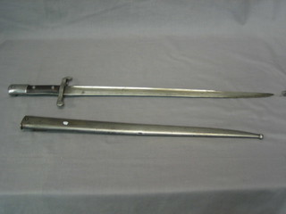 A 19th Century Continental steel single edge bayonet, the blade dated 1886 contained in a steel scabbard