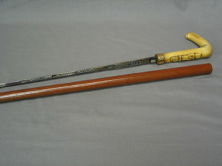 A Victorian sword stick with etched stiletto blade marked Toledo with ivory and carved horn handle, contained in a Melacca cane