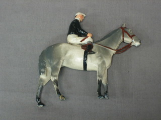 A Britains figure of a race horse with jockey up (leg f)