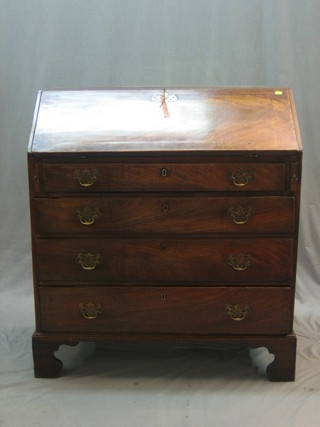 A Georgian mahogany bureau, the fall front revealing a well fitted interior with cupboards, pigeon holes and drawers and 2 secret drawers, above 4 long graduated drawers, raised on bracket feet 36"