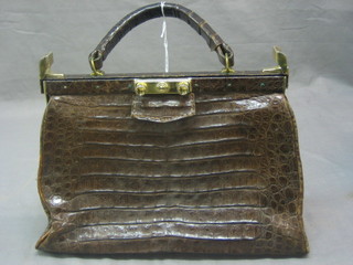 A crocodile hand bag with gilt mounts