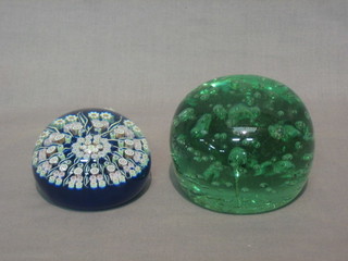 2 circular glass paperweights