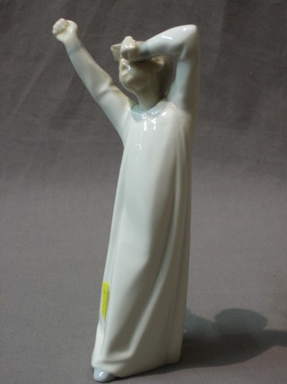 A Lladro figure of a standing boy 8"