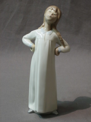 A Lladro figure of a standing girl with hand on hips 8"