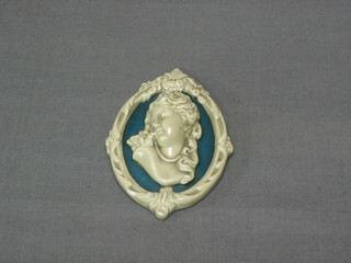 An oval pottery plaque decorated a head & shoulders portrait of a lady 3 1/2" oval
