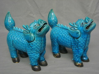 A pair of Oriental turquoise porcelain figures of standing Dogs of Fo 8"