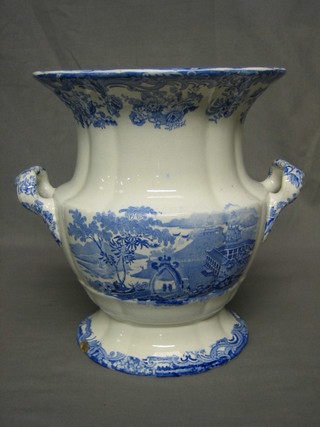 A 19th Century blue and white pottery twin handled Leech pot of companular form with transfer temple decoration, raised on a circular spreading foot (cracked and some chips) 13"