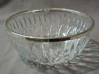 A circular glass bowl with silver plated rim 9"