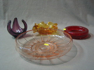 A circular pink glass bowl 10", a red Whitefriars ashtray 6", a yellow bubble glass ashtray 8" and shaped glass sculpture 4" 