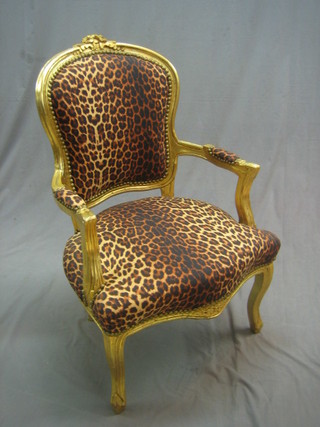 A pair of gilt painted salon chairs upholstered in leopard print material