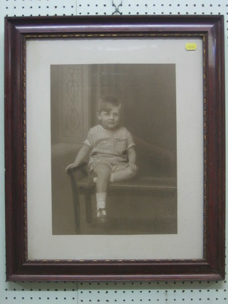 An early black and white portrait photograph of a seated child 15" x 11"