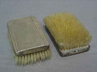 A pair of silver backed military hair brushes with engine turned decoration, London 1952