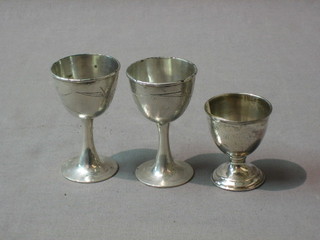 A silver egg cup and 2 Eastern white metal egg cups