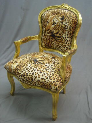 A pair of gilt painted salon chairs upholstered in material decorated leopards