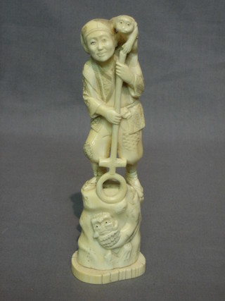 A 19th Century Japanese carved ivory figure of a standing man with monkey, the base with 3 character mark 9"