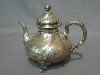 A Continental Rococo style embossed white metal teapot of melon form, raised on 4 pierced supports, base marked Gebr.Friedland 800