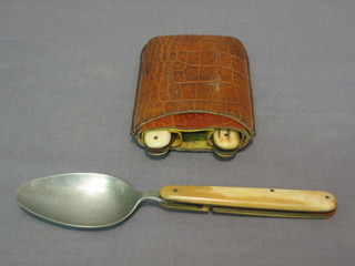 A 19th/20th Century 3 piece folding campaign cutlery set comprising knife, spoon and fork with corkscrew, all contained in bone grips (knife has chip to handle)