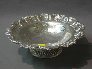 A circular silver plated bowl with bracketed border and wavy decoration by Mappin & Webb, raised on a spreading foot 10"