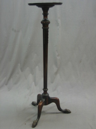 An Edwardian Georgian style mahogany torchere raised on tripod supports