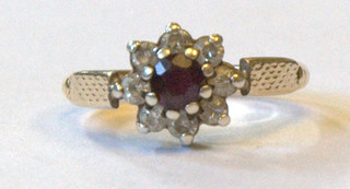 A lady's gold cluster dress ring set red and opaque stones