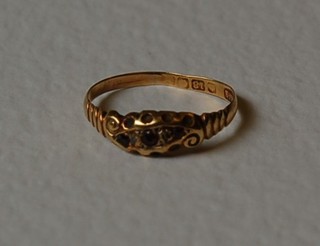 An 18ct gold dress ring set rubies and diamonds
