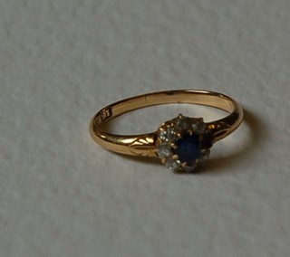 An 18ct gold dress ring set blue and white stones (1 stone missing)