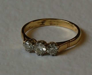 A lady's yellow gold engagement/dress ring set 3 diamonds