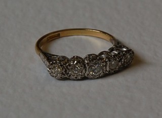 A lady's gold 5 stone illusion diamond set dress ring