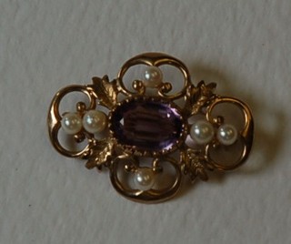 A lady's 9ct pierced gold brooch set an amethyst and pearls
