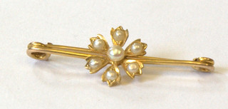 A gold bar brooch of floral design set demi-pearls