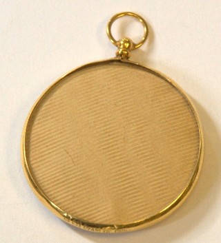 A gold double sided photo locket