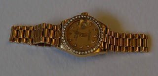 A lady's Rolex Oyster Perpetual Datejust wristwatch contained in an 18ct Swiss gold case with integral bracelet, the bezel set numerous diamonds