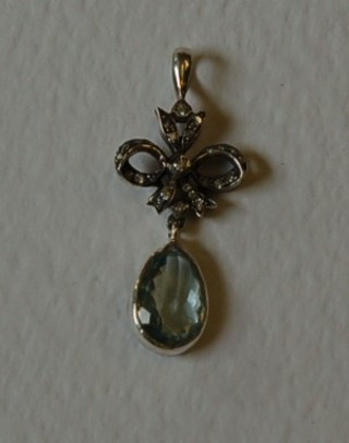 A pendant set an aquamarine and diamonds
