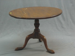 A 19th Century circular  mahogany snap top tea table raised on a pillar and tripod base, 28"