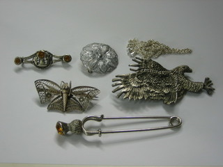 A silver filigree brooch in the form of a butterfly, a circular silver brooch, a silver chain, a kilt pin, a Scottish brooch and a brooch in the form of an eagle