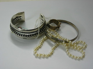 A silver bracelet, a silver bangle, a gilt metal ring and a string of simulated pearls